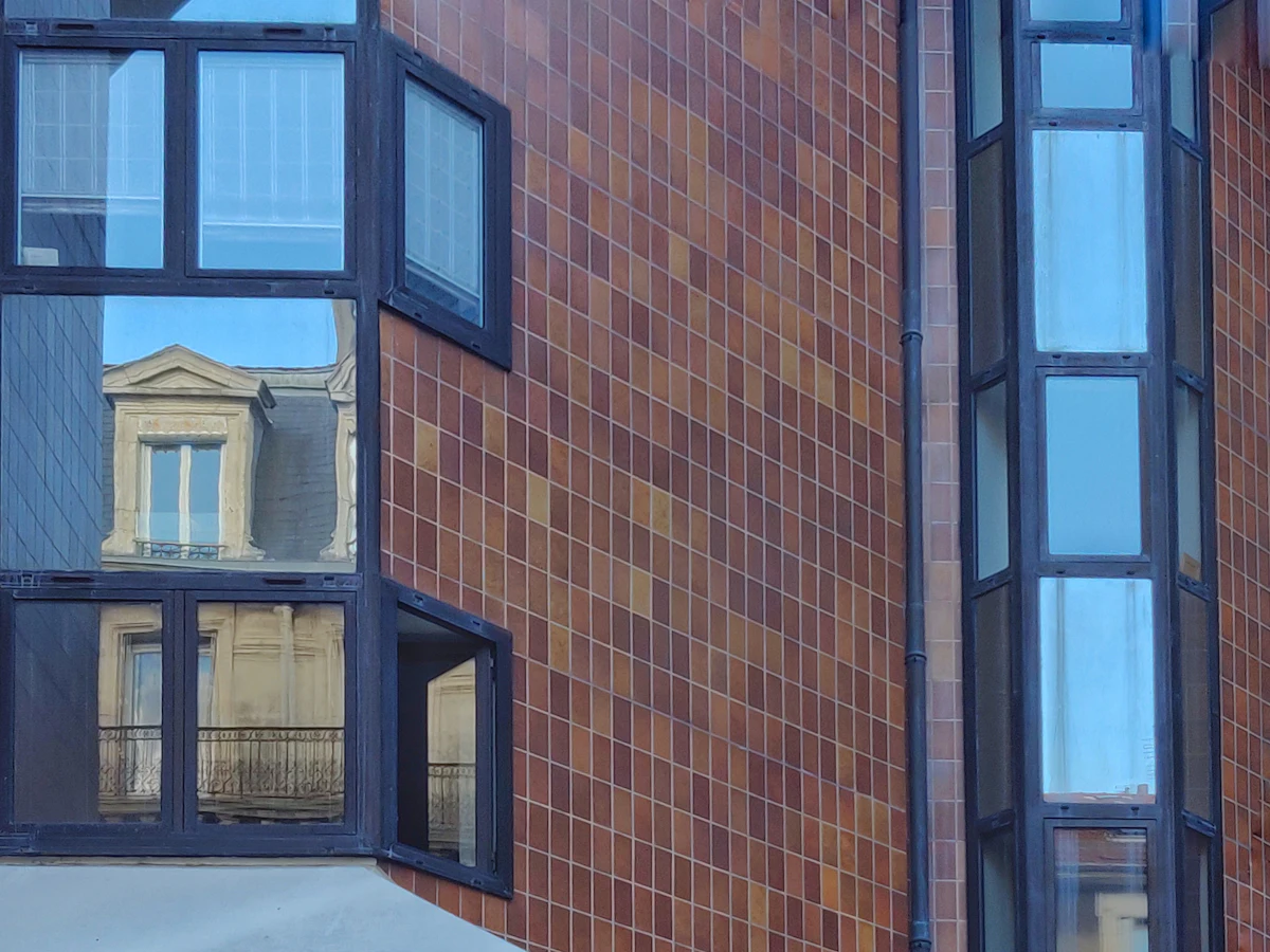 brown brick building with blue window
